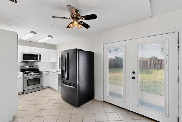 1225 Briarcove Dr, Richardson, TX 75081 - kitchen with stainless steel appliances, white cabinetry, french doors, a textured ceiling, and plenty of natural light