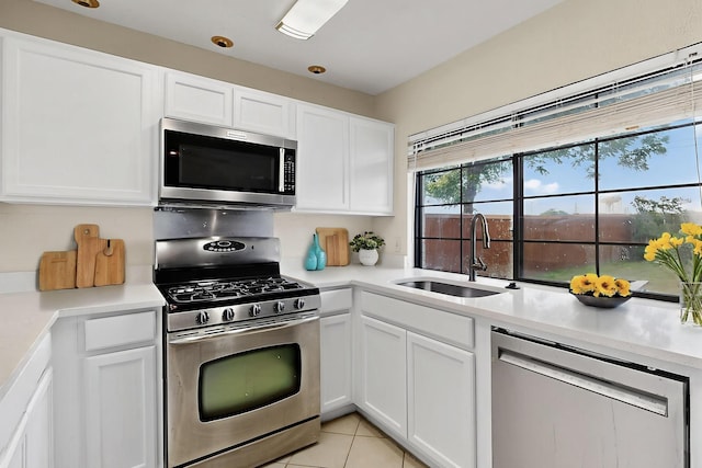 1225 Briarcove Dr, Richardson, TX 75081 - kitchen featuring stainless steel appliances, white cabinetry, light countertops, and light tile patterned floors