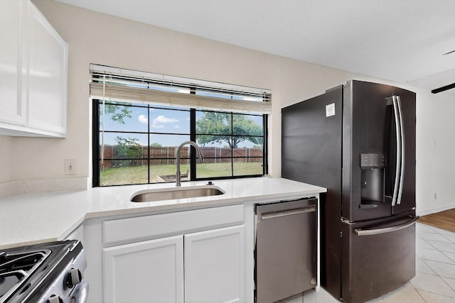 1225 Briarcove Dr, Richardson, TX 75081 - kitchen with appliances with stainless steel finishes, white cabinets, and light countertops