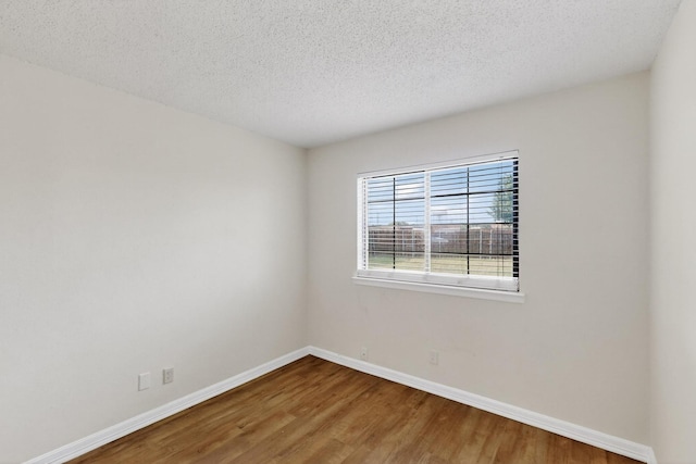 1225 Briarcove Dr, Richardson, TX 75081 - spare room featuring wood finished floors and a textured ceiling