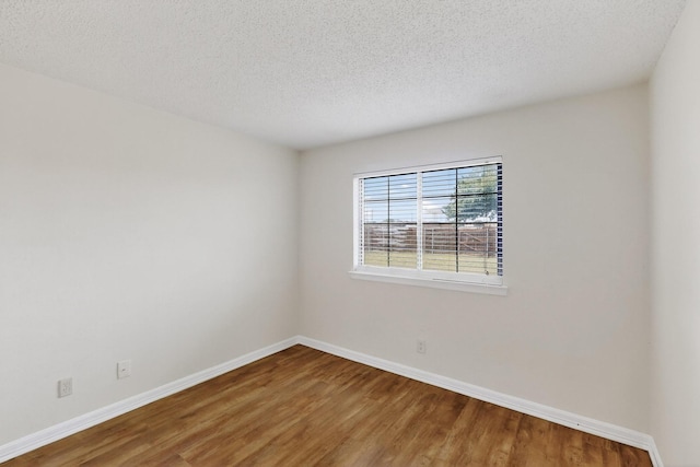 1225 Briarcove Dr, Richardson, TX 75081 - empty room with wood finished floors and a textured ceiling