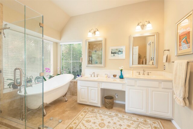 2903 Moss Creek Ct, Mckinney, TX 75072 - bathroom featuring double vanity, a freestanding bath, a stall shower, lofted ceiling, and tile patterned floors