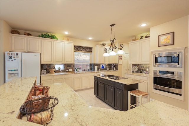 2903 Moss Creek Ct, Mckinney, TX 75072 - kitchen featuring appliances with stainless steel finishes, backsplash, light stone countertops, and recessed lighting