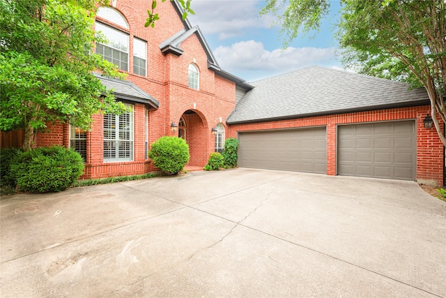 2903 Moss Creek Ct, Mckinney, TX 75072 - traditional-style house featuring brick siding, roof with shingles, and driveway