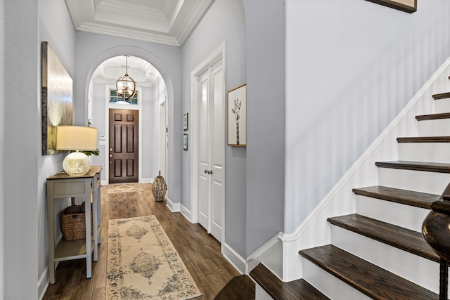1861 Snapdragon Rd, Frisco, TX 75033 - foyer featuring crown molding, stairs, wood finished floors, a chandelier, and arched walkways