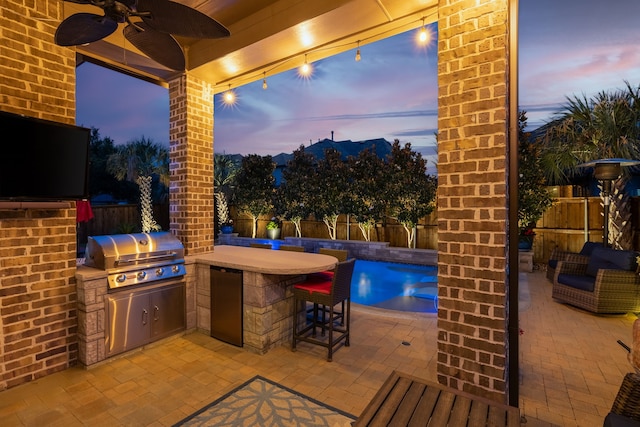 1861 Snapdragon Rd, Frisco, TX 75033 - fenced backyard featuring an outdoor kitchen, a patio area, and a ceiling fan