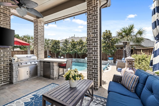 1861 Snapdragon Rd, Frisco, TX 75033 - fenced backyard with an outdoor kitchen, an outdoor bar, an outdoor hangout area, a patio area, and a ceiling fan