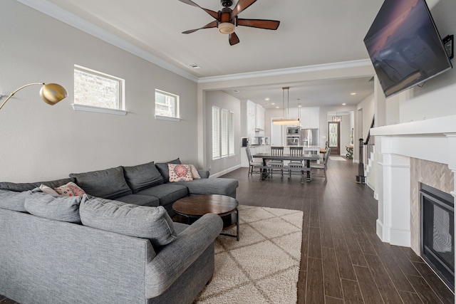 4001 Bamboo Trl, Mckinney, TX 75071 - living room with a ceiling fan, dark wood-type flooring, ornamental molding, a tile fireplace, and recessed lighting