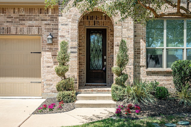 4001 Bamboo Trl, Mckinney, TX 75071 - property entrance featuring brick siding, a garage, and concrete driveway