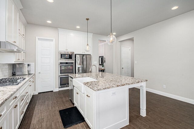 4001 Bamboo Trl, Mckinney, TX 75071 - kitchen featuring stainless steel appliances, recessed lighting, a breakfast bar, dark wood-type flooring, and white cabinetry