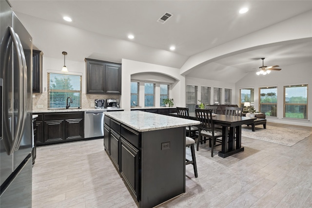 1501 Birdsong Ct, Midlothian, TX 76065 - kitchen with stainless steel appliances, a ceiling fan, vaulted ceiling, plenty of natural light, and recessed lighting
