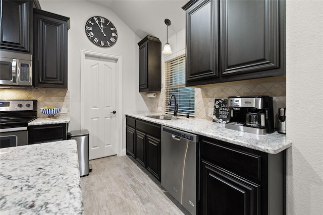 1501 Birdsong Ct, Midlothian, TX 76065 - kitchen featuring appliances with stainless steel finishes, decorative backsplash, dark cabinets, and lofted ceiling
