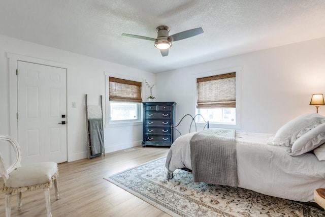 105 Causeway Ct, Gun Barrel City, TX 75156 - bedroom featuring wood finished floors, ceiling fan, and a textured ceiling