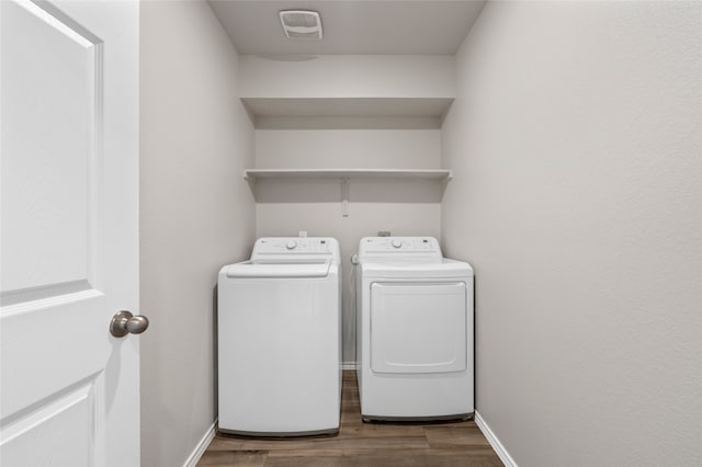 6941 Guadalupe Rd, China Spring, TX 76633 - washroom with washer and clothes dryer and wood finished floors
