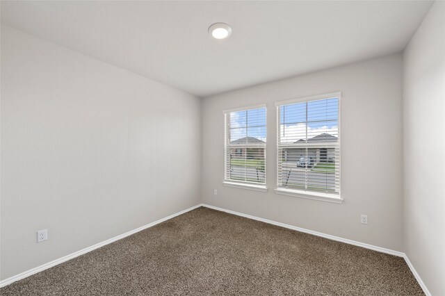 6941 Guadalupe Rd, China Spring, TX 76633 - spare room with dark carpet and baseboards