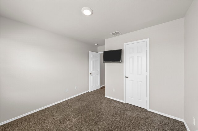 6941 Guadalupe Rd, China Spring, TX 76633 - unfurnished bedroom with dark carpet and baseboards