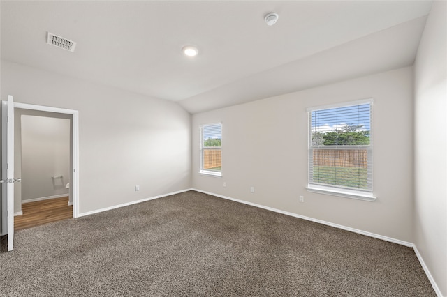 6941 Guadalupe Rd, China Spring, TX 76633 - unfurnished room featuring dark colored carpet, a smoke detector, and vaulted ceiling