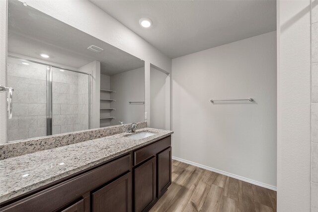 6941 Guadalupe Rd, China Spring, TX 76633 - bathroom featuring wood finished floors, vanity, and a shower stall
