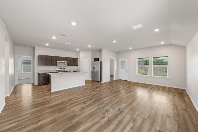 6941 Guadalupe Rd, China Spring, TX 76633 - kitchen with appliances with stainless steel finishes, open floor plan, recessed lighting, light countertops, and light wood-style flooring