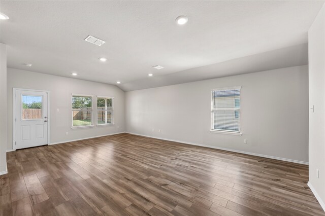 6941 Guadalupe Rd, China Spring, TX 76633 - spare room featuring wood finished floors, recessed lighting, and vaulted ceiling