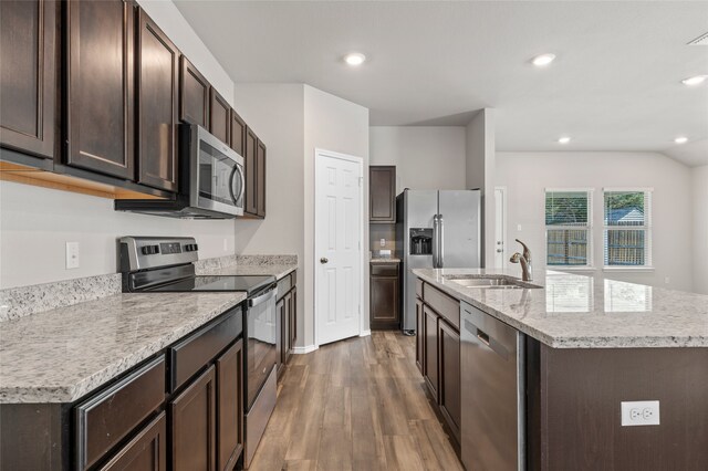6941 Guadalupe Rd, China Spring, TX 76633 - kitchen with appliances with stainless steel finishes, wood finished floors, dark brown cabinetry, a kitchen island with sink, and recessed lighting