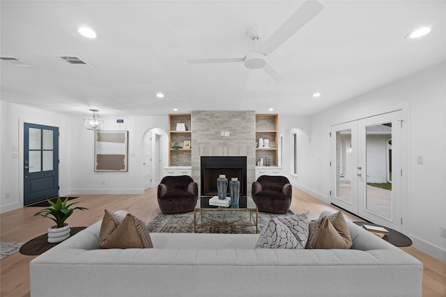 7150 Blairview Dr, Dallas, TX 75230 - living room featuring recessed lighting, light wood-style floors, a ceiling fan, french doors, and arched walkways