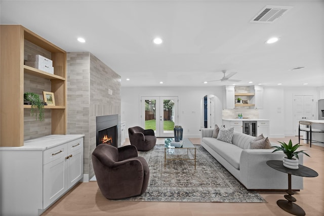 7150 Blairview Dr, Dallas, TX 75230 - living room featuring wine cooler, a fireplace, recessed lighting, bar, and arched walkways