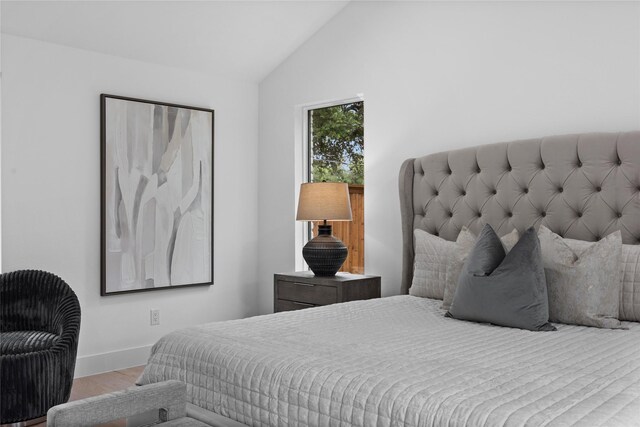7150 Blairview Dr, Dallas, TX 75230 - bedroom featuring wood finished floors and vaulted ceiling