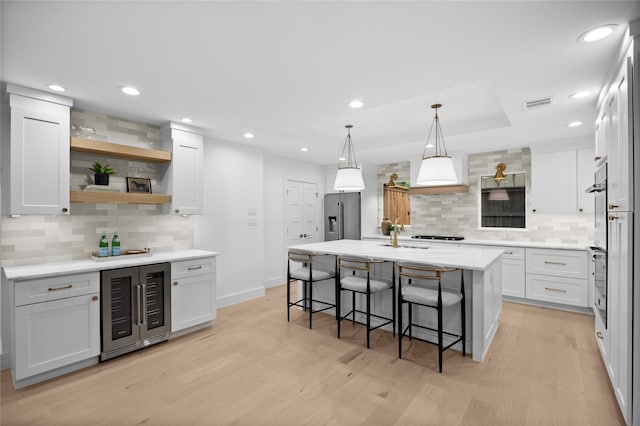 7150 Blairview Dr, Dallas, TX 75230 - kitchen featuring beverage cooler, stainless steel fridge with ice dispenser, tasteful backsplash, light wood-style floors, and recessed lighting