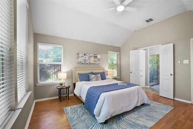 733 Atascosa Ave, Fort Worth, TX 76120 - bedroom featuring vaulted ceiling, wood finished floors, multiple windows, a ceiling fan, and ensuite bath
