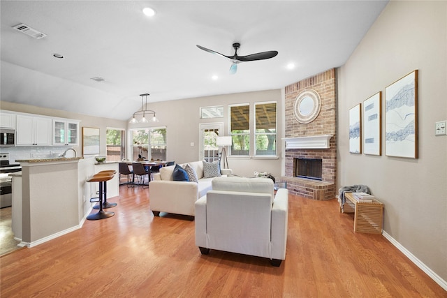 733 Atascosa Ave, Fort Worth, TX 76120 - living area featuring light wood-style flooring, ceiling fan, a fireplace, and recessed lighting
