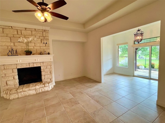 1413 Discovery Bay Dr, Frisco, TX 75036 - unfurnished living room with tile patterned floors, a stone fireplace, and ceiling fan