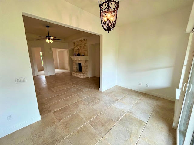 1413 Discovery Bay Dr, Frisco, TX 75036 - unfurnished living room with ceiling fan, a stone fireplace, and a chandelier