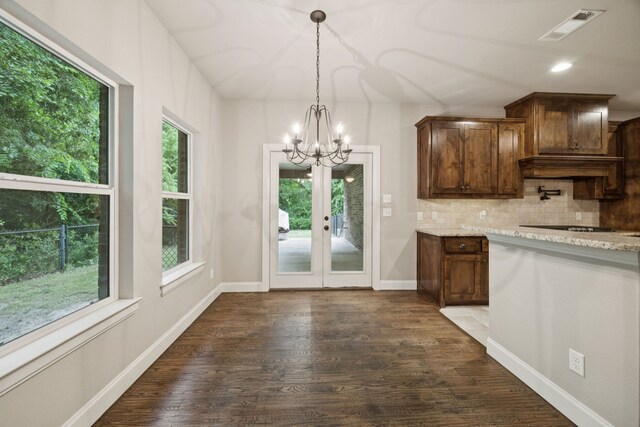 149 Ty Ln, Azle, TX 76020 - kitchen with a chandelier, dark wood-type flooring, tasteful backsplash, hanging light fixtures, and french doors