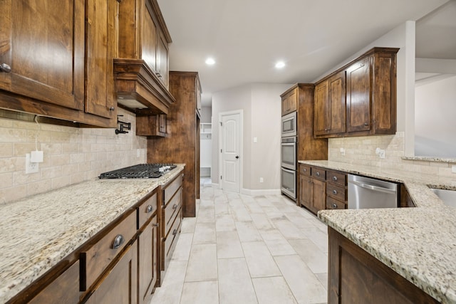 149 Ty Ln, Azle, TX 76020 - kitchen with stainless steel appliances, light stone countertops, tasteful backsplash, recessed lighting, and dark brown cabinets