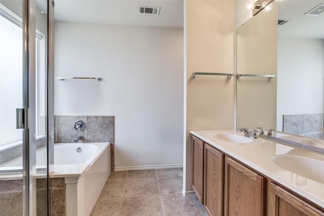 205 Bear Trl, Waxahachie, TX 75165 - bathroom featuring a garden tub, double vanity, and tile patterned flooring
