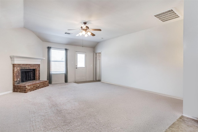 205 Bear Trl, Waxahachie, TX 75165 - unfurnished living room featuring ceiling fan, light colored carpet, lofted ceiling, and a brick fireplace