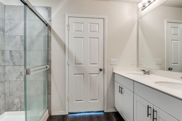 721 Brockwell Bnd, Forney, TX 75126 - bathroom with a stall shower, wood finished floors, and double vanity