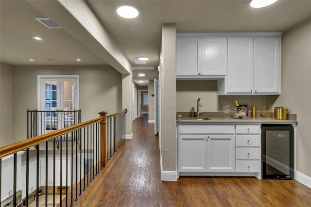 354 Loma Alta Dr, Flower Mound, TX 75022 - kitchen with wine cooler, dark wood-type flooring, white cabinetry, light countertops, and recessed lighting