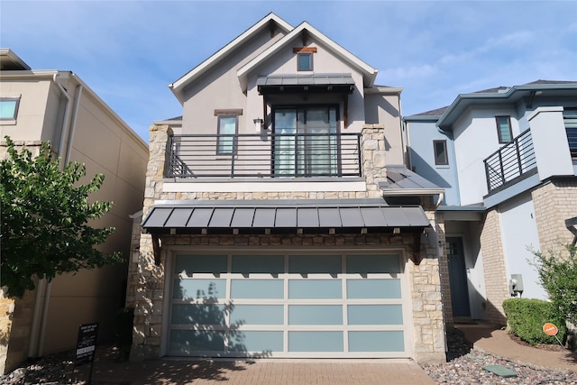 8327 Nunley Ln, Dallas, TX 75231 - view of front facade featuring a balcony, a standing seam roof, stucco siding, and stone siding