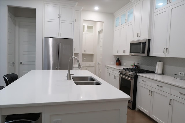 8327 Nunley Ln, Dallas, TX 75231 - kitchen with stainless steel appliances, white cabinets, light countertops, a breakfast bar area, and recessed lighting