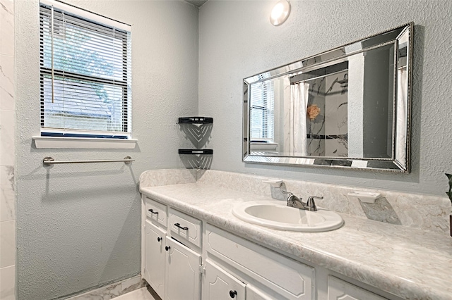 1803 Windsor Dr, Arlington, TX 76012 - full bathroom featuring plenty of natural light, vanity, curtained shower, and a textured wall