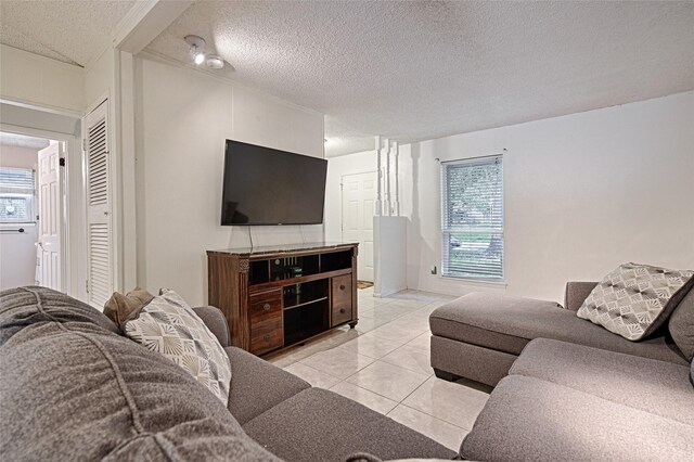 1803 Windsor Dr, Arlington, TX 76012 - living room featuring a textured ceiling and light tile patterned floors