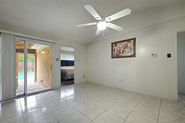 1803 Windsor Dr, Arlington, TX 76012 - empty room with light tile patterned floors, vaulted ceiling, a ceiling fan, and a textured ceiling