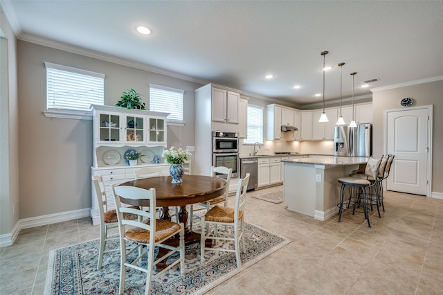 8031 Reservoir Dr, Frisco, TX 75036 - dining area with crown molding, recessed lighting, and light tile patterned flooring