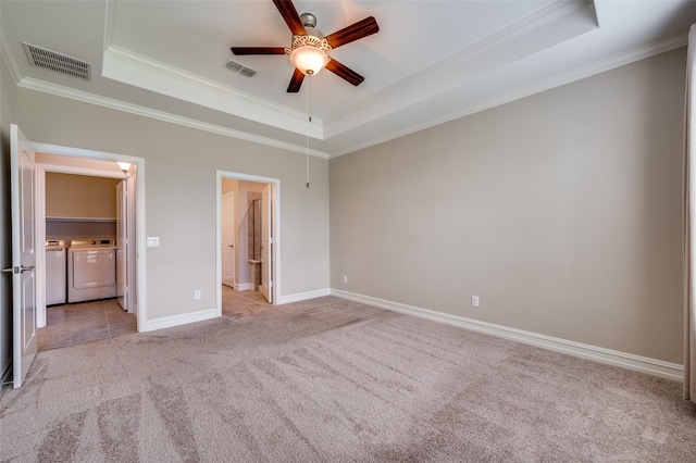 8031 Reservoir Dr, Frisco, TX 75036 - unfurnished bedroom with washing machine and clothes dryer, a tray ceiling, light carpet, crown molding, and connected bathroom