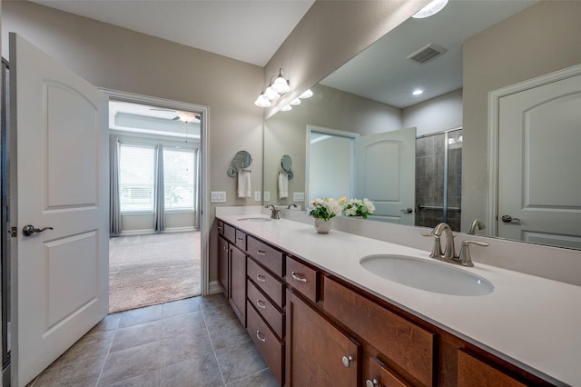 8031 Reservoir Dr, Frisco, TX 75036 - bathroom featuring double vanity, tiled shower, and tile patterned floors