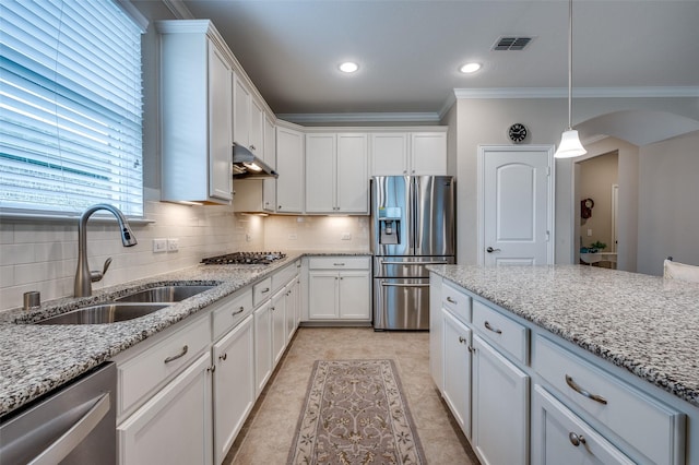 8031 Reservoir Dr, Frisco, TX 75036 - kitchen featuring stainless steel appliances, crown molding, arched walkways, white cabinets, and recessed lighting