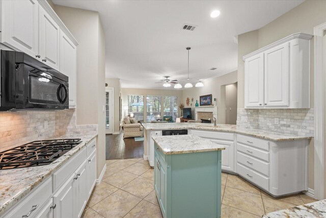 3102 Hidden Springs Dr, Corinth, TX 76210 - kitchen featuring black appliances, open floor plan, white cabinetry, and recessed lighting