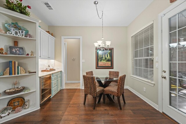 3102 Hidden Springs Dr, Corinth, TX 76210 - dining area featuring wine cooler, a chandelier, and dark wood-style flooring